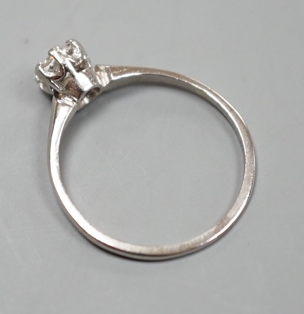 A white metal (stamped plat) and solitaire diamond ring, size O, gross weight 2.3 grams.